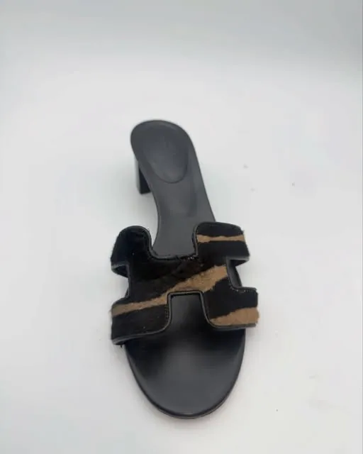 A black leather slide sandal with a calf-hair strap, re-soled and re-heeled