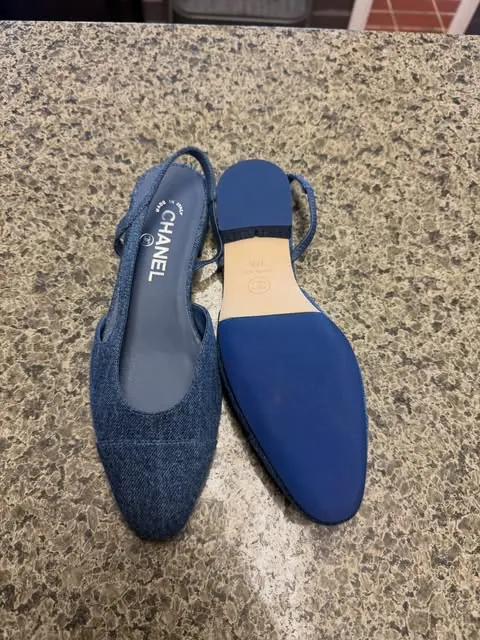 A blue denim Chanel slingback next to the matching blue sole fitted to its pair
