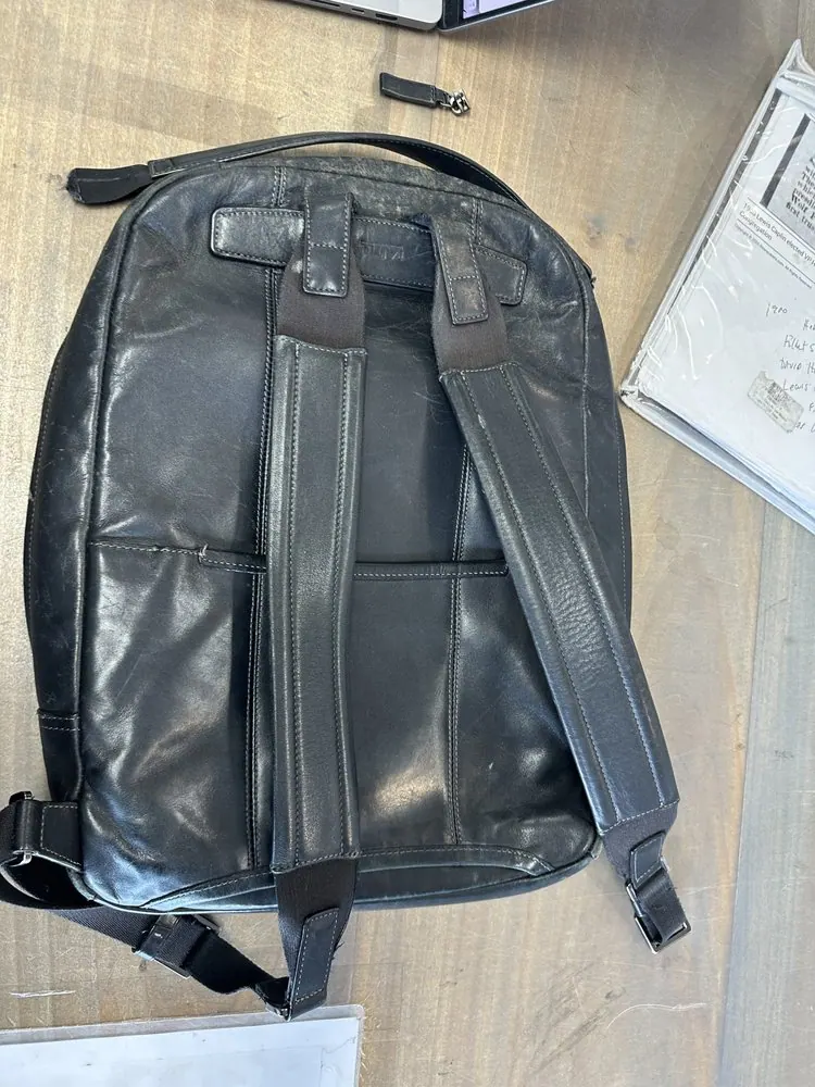 The Tumi bag's zipper and handle repair