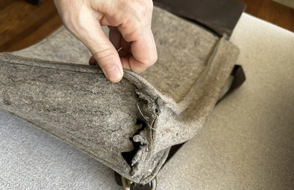 A felt and leather bag with the bottom corners reinforced