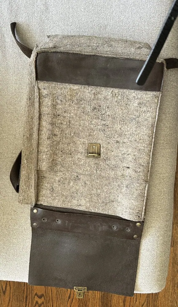 The bottom of a felt and leather bag, repaired and reinforced