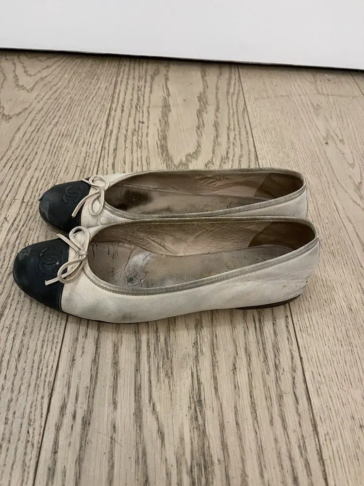 Before: a pair of cap-toe ballet flats, scuffed and dirty