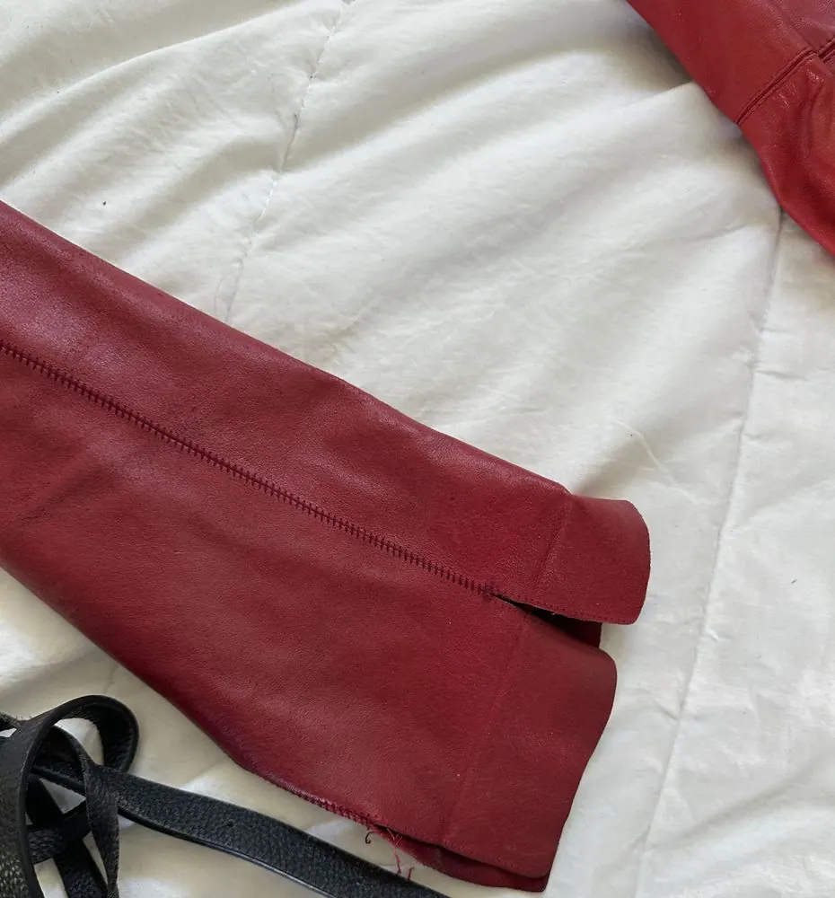 Sleeve hems and collar work on a long red leather coat