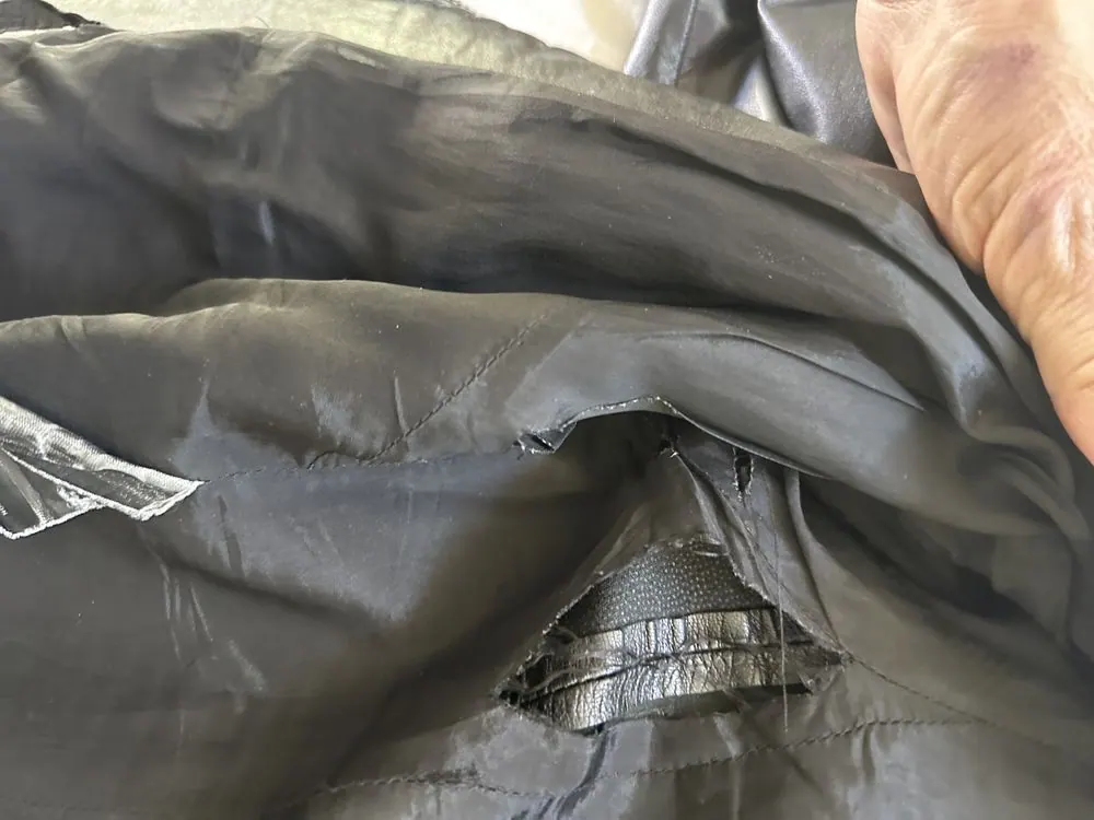 The interior of a Prada leather jacket, stitched