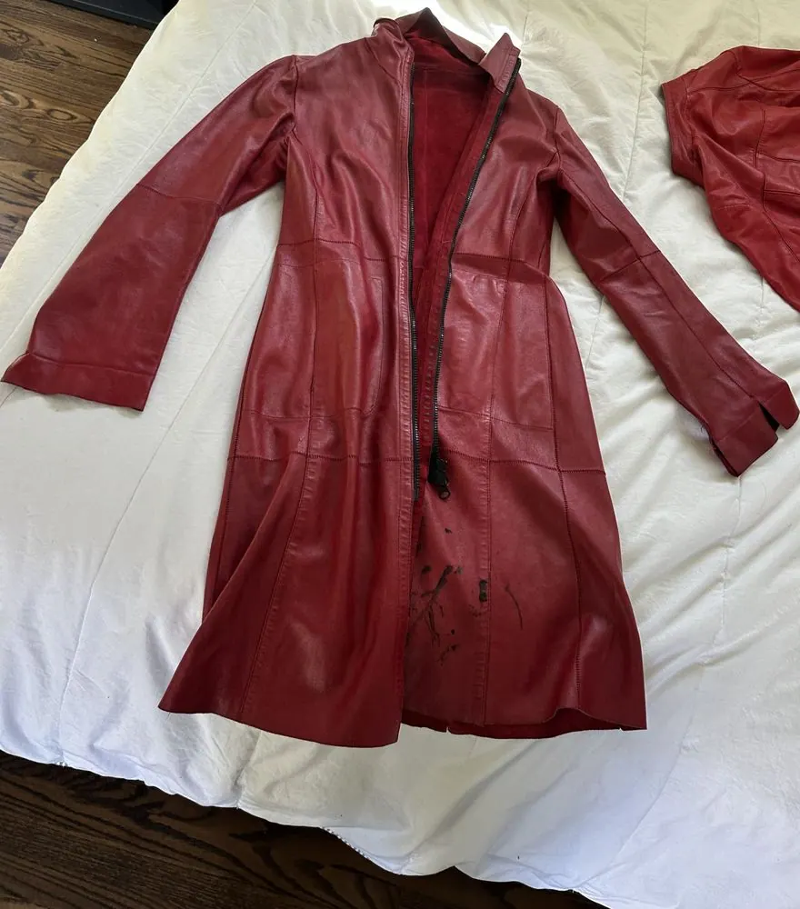 A long red leather coat in for sleeve hems and a collar