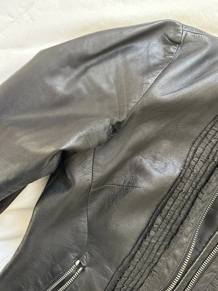 Underarm seam repair on a black leather jacket