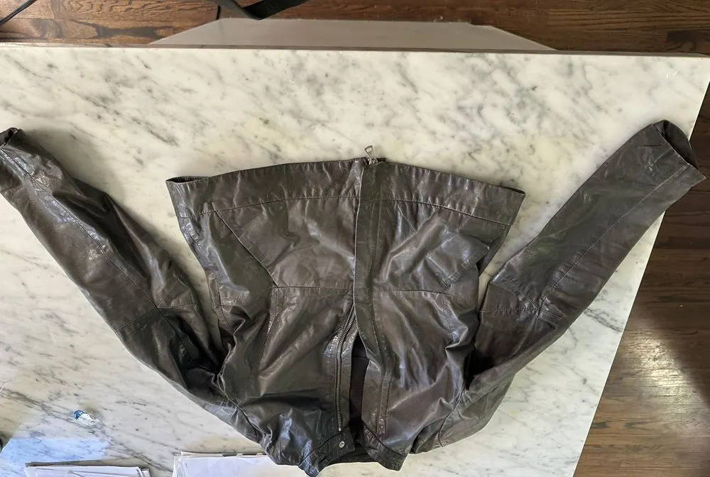 The jammed zipper on a grey leather jacket