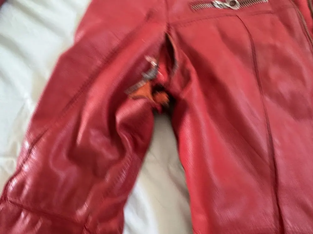A red leather jacket with the right underarm sewn and the collar cleaned
