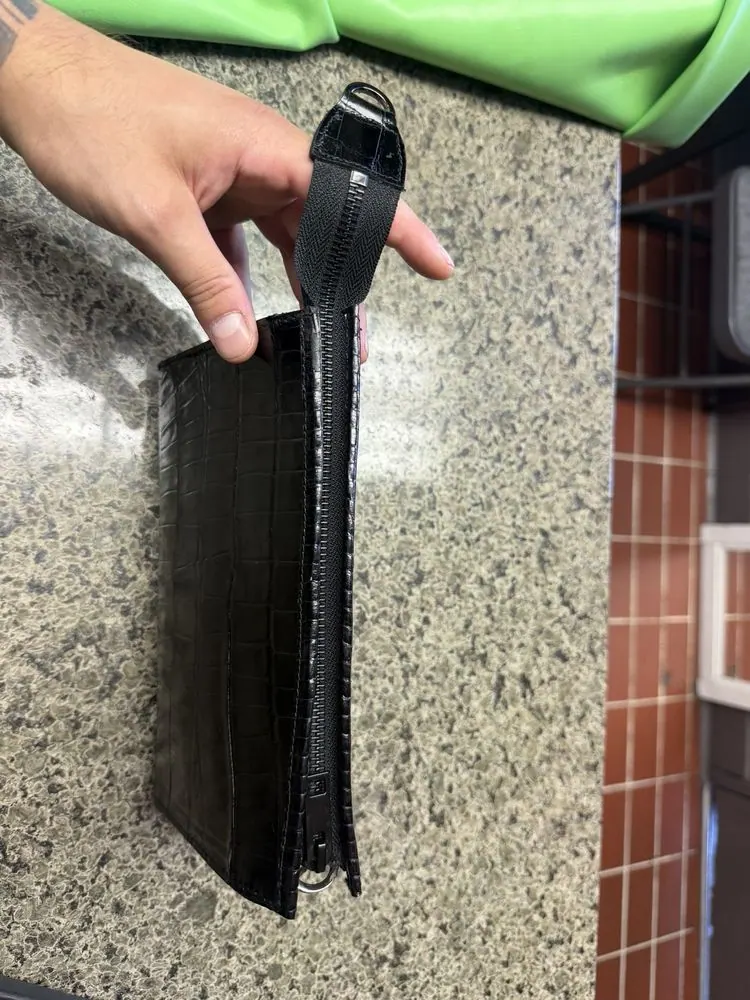 A leather belt held up and checked over the counter