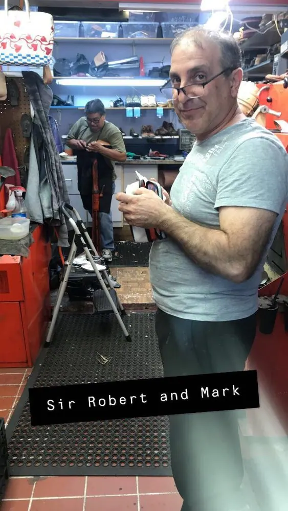Tins of shoe cream and polish on the shelf at Robert's Shoe Repair